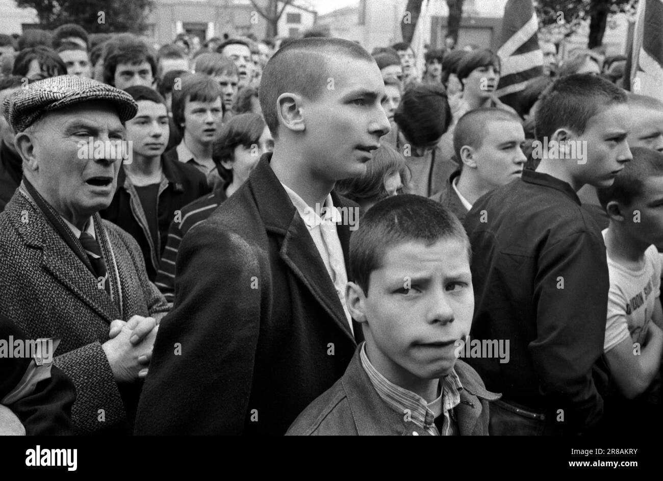 Skinheads style, the hairstyle was designed they though as if to look tough. They are at a National Front, 'Defend Our Old Folk Repatriate Muggers' rally and march through Southwark. Southwark, South London England circa 1980. 1980s UK HOMER SYKES Stock Photo