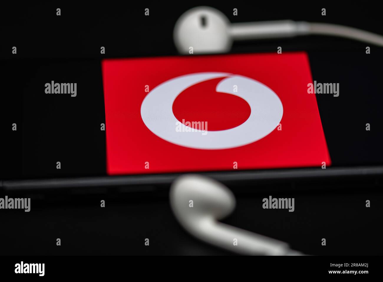 Rheinbach, Germany  20 June 2023, The brand logo of the mobile phone company 'Vodafone' on the display of a smartphone (focus on the brand logo) Stock Photo