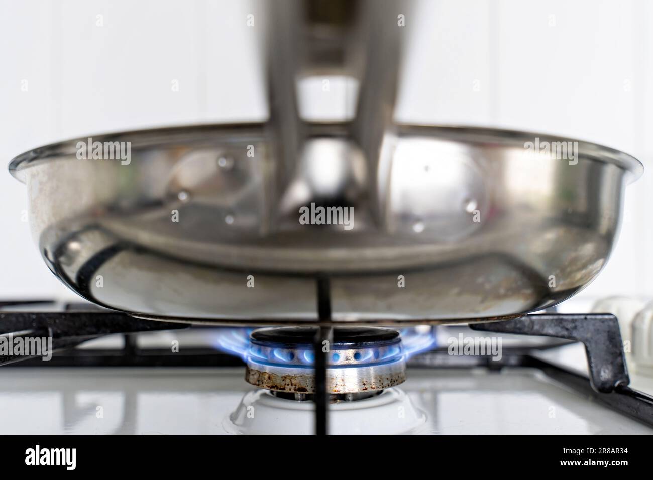 stainless steel pan on gas stove Stock Photo Alamy
