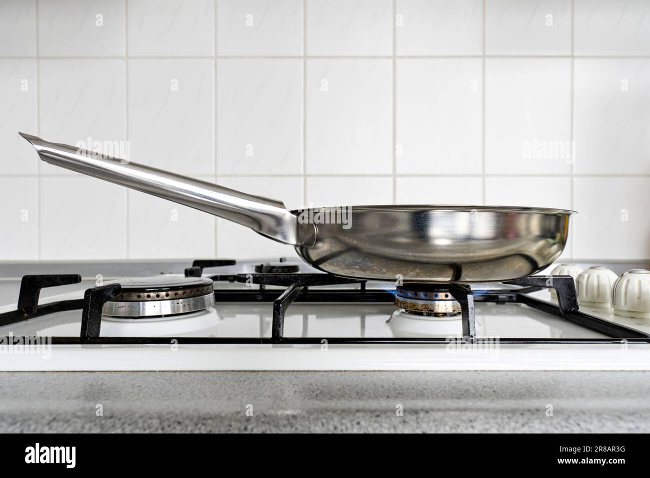 stainless steel pan on gas stove Stock Photo Alamy