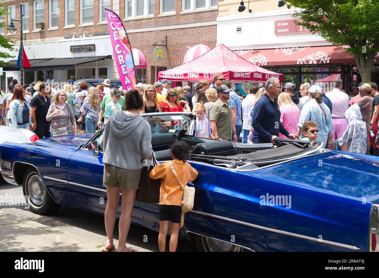Father's Day Auto Show - Hyannis, Massachusetts, Cape Cod - USA. Looking over an automobile on display with the crowd in the background Stock Photo