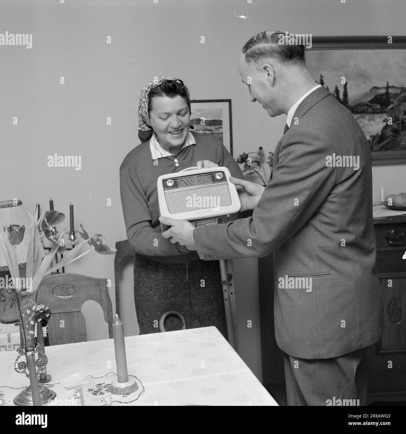 Current 1960 : The radio gifts Every14. Today, 'Aktuell' is handing out a Mascot radio to people who want a radio set, but cannot afford it due to conditions over which they themselves are not masters. This is our 8th radio gift.  Aktuell's employee brings the radio gift to Miss Annie Carlsen, Ole Bull's gt. 13, Oslo.  Photo: Ivar Aaserud / Aktuell / NTB ***PHOTO NOT IMAGE PROCESSED*** Stock Photo