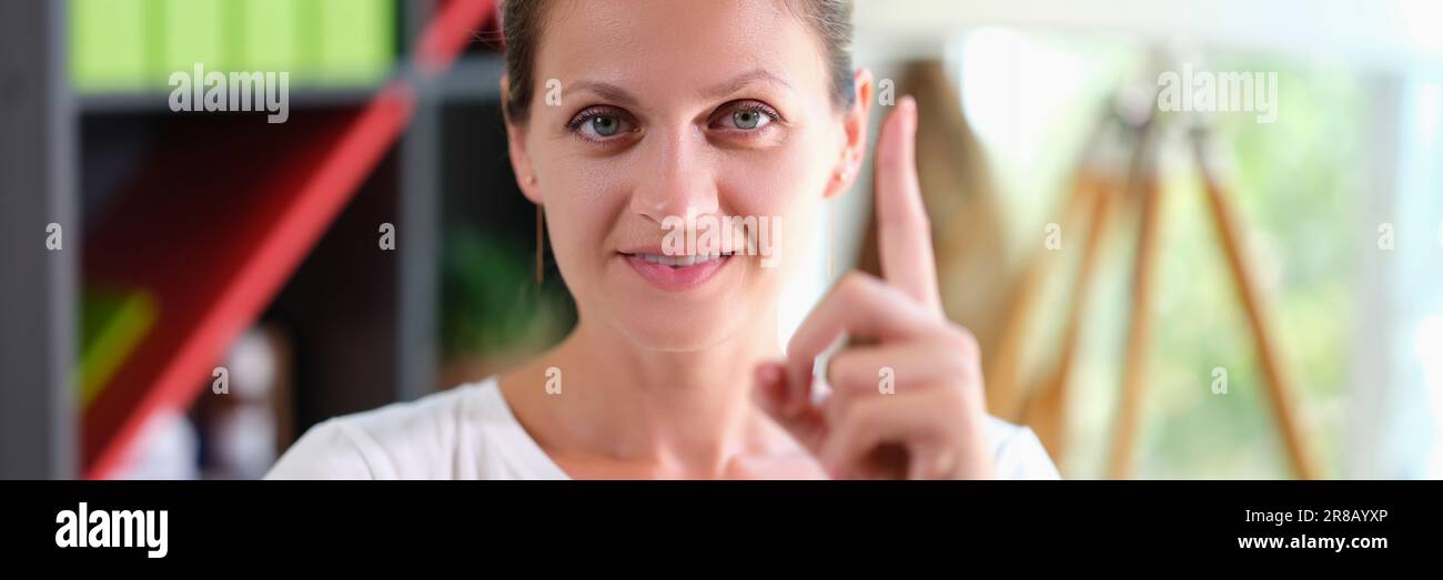 Portrait of happy smiling woman holding thumbs up Stock Photo - Alamy
