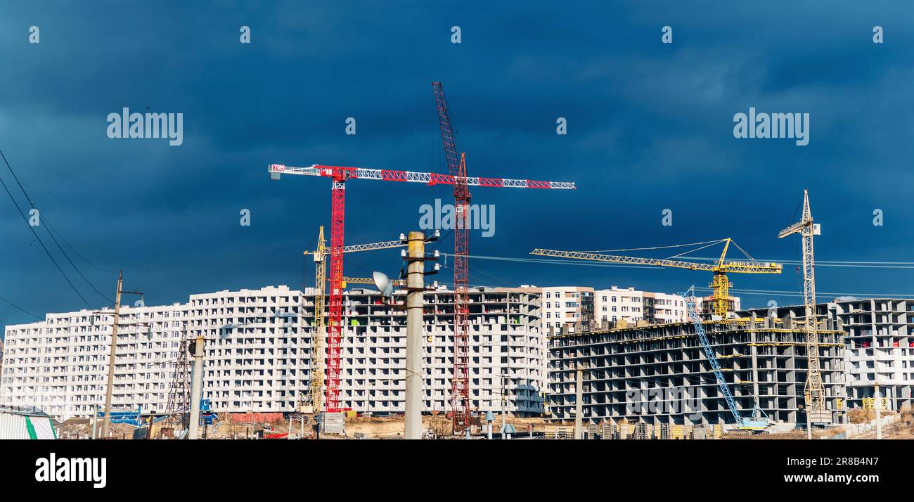Construction of apartment buildings under blue sky. Cranes on ...