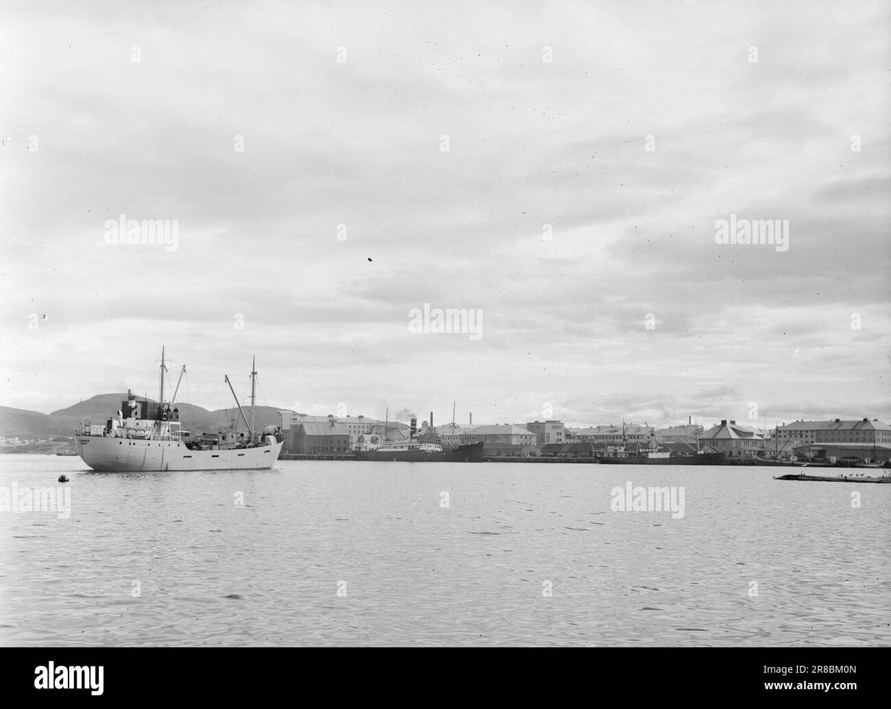 Current 22-1948: Bodø's new face takes shapeOn 27 May 1940 — i.e. more than eight years ago — 30 German bombers ravaged Bodø for a few sunny afternoons. The result of the visit was that 420 houses were burnt to the ground or blown to pieces. 837 flats were totally destroyed, and 3,707 of the city's approximately 6,000 inhabitants were left homeless that evening. This is what it looked like in Bodø these days eight years ago. It's better now, and it's getting better day by day. Bodø has come a long way in alleviating the need for housing, but the lack of materials means that things are slow.  P Stock Photo