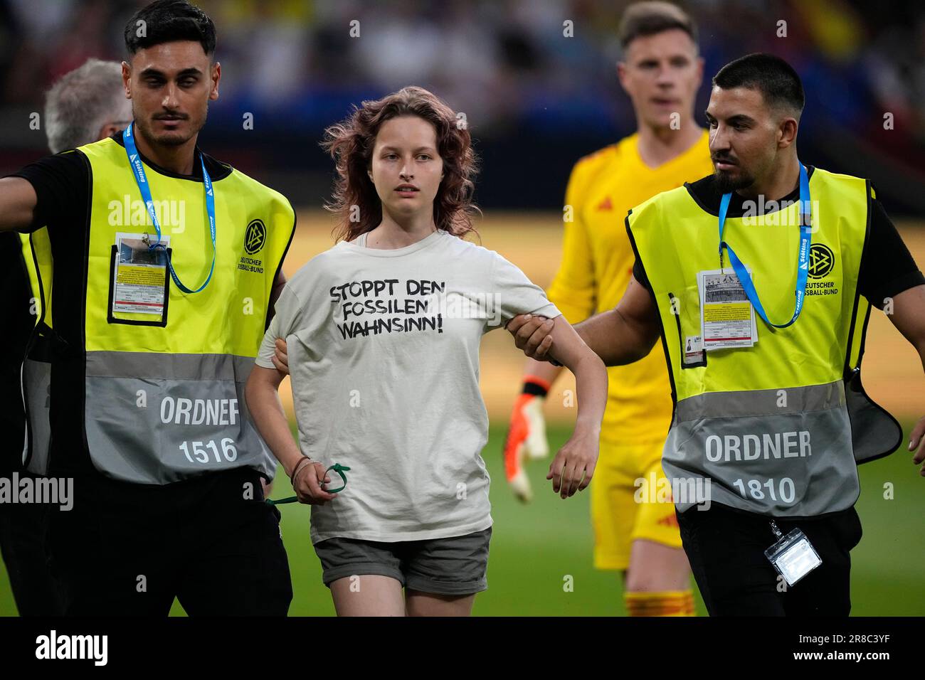 A Climate activist of the self named group "last generation" that invaded  the pitch is taken away by security during an international friendly soccer  match between Germany and Colombia at Veltins-Arena, in