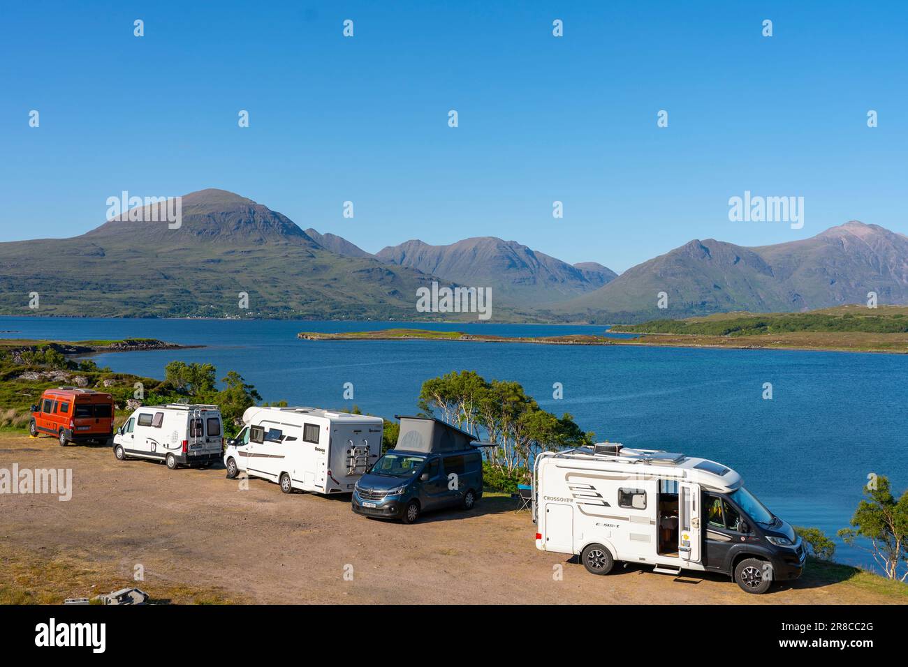 Tourist motorhomes and camper vans parked beside Loch Torridon in the Scottish Highlands on North Coast 500 road trip, Scotland, UK Stock Photo