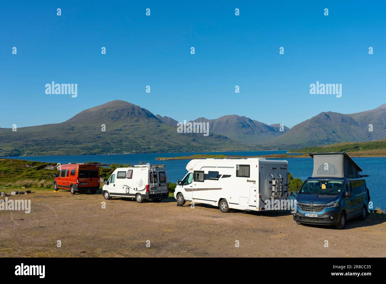 Tourist motorhomes and camper vans parked beside Loch Torridon in the Scottish Highlands on North Coast 500 road trip, Scotland, UK Stock Photo