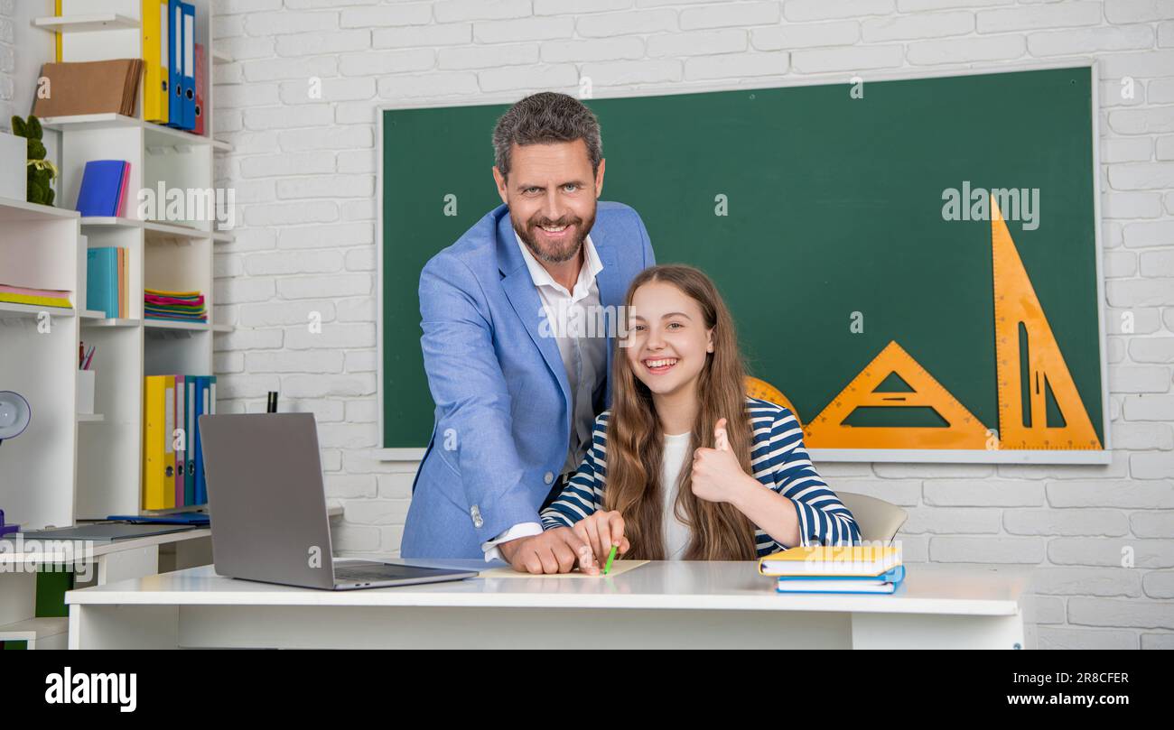 school. positive kid with teacher in classroom use laptop. back to ...