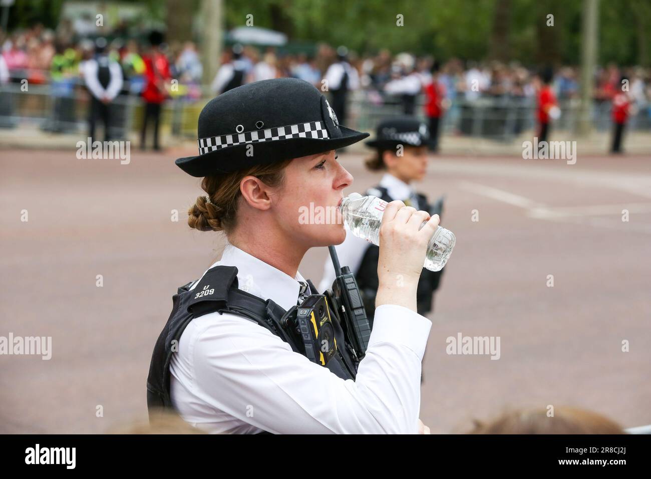 London, UK. 17th June, 2023. A police officer drinks water during hot weather in London at the Trooping the Colour parade. The parade is held to mark the official birthday of King Charles III. This year will be the first Trooping the Colour held for King Charles III since he ascended to the throne following the death of Queen Elizabeth II on 8 September 2022. (Photo by Steve Taylor/SOPA Images/Sipa USA) Credit: Sipa USA/Alamy Live News Stock Photo
