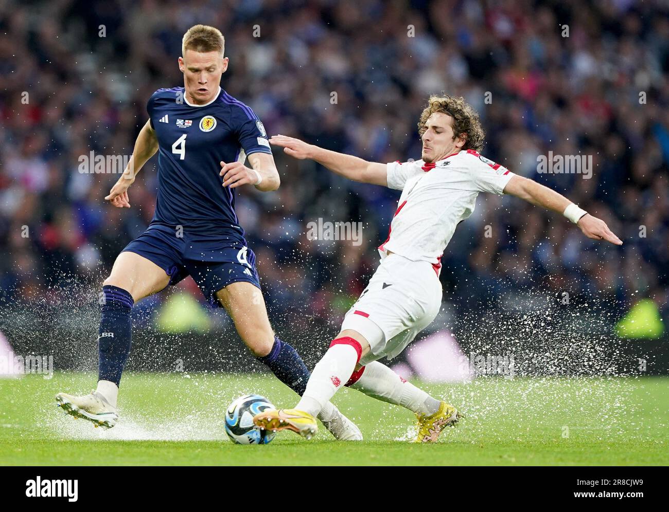 Scotland's Scott McTominay (left) and Georgia's Luka Gagnidze battle for the ball during the UEFA Euro 2024 Qualifying Group A match at Hampden Park, Glasgow. Picture date: Tuesday June 20, 2023. Stock Photo