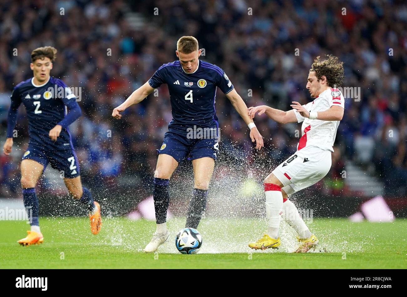 Scotland's Scott McTominay (centre) and Georgia's Luka Gagnidze battle for the ball during the UEFA Euro 2024 Qualifying Group A match at Hampden Park, Glasgow. Picture date: Tuesday June 20, 2023. Stock Photo