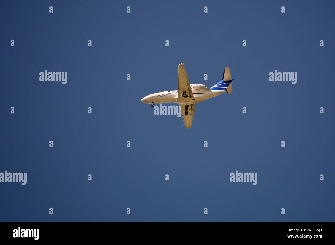 A Cessna 525 Citation private jet approaches a landing strip in