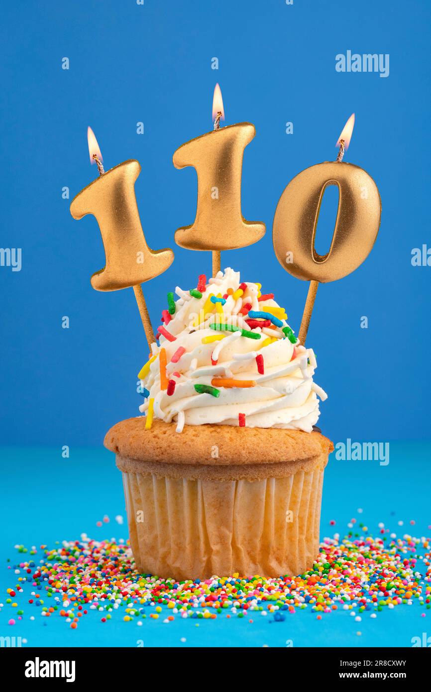 Birthday cake with candle number 110 - Blue background Stock Photo - Alamy