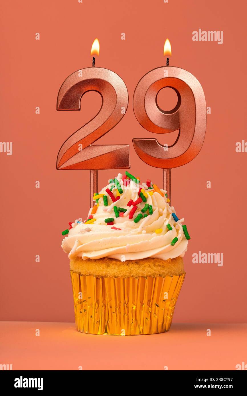 Birthday cake with candle number 29 - Coral fusion background Stock Photo
