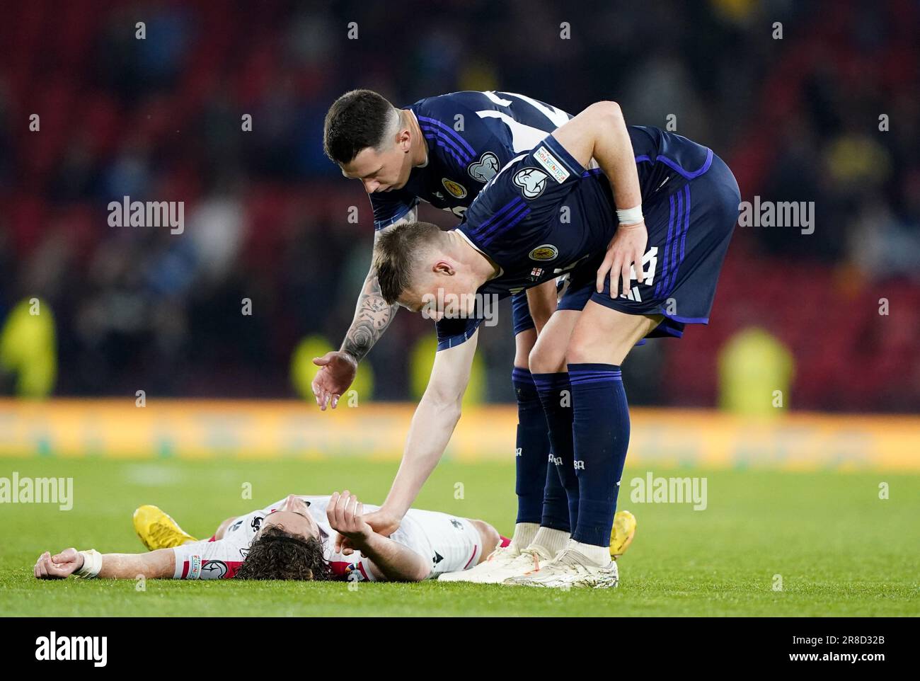 Scotland's Ryan Jack (back) and Scott McTominay help up Georgia's Luka Gagnidze after the UEFA Euro 2024 Qualifying Group A match at Hampden Park, Glasgow. Picture date: Tuesday June 20, 2023. Stock Photo