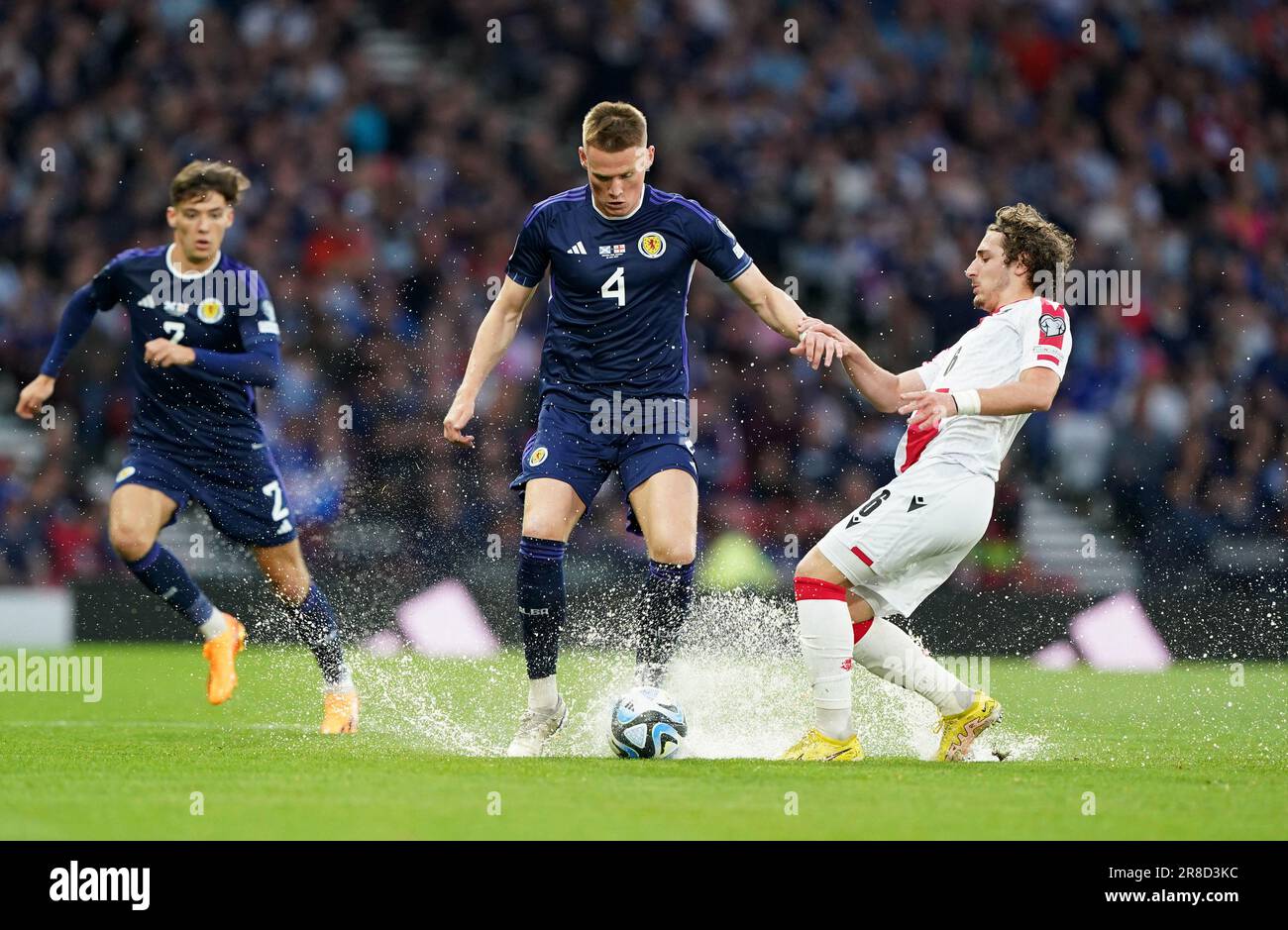 Scotland's Scott McTominay (centre) and Georgia's Luka Gagnidze battle for the ball during the UEFA Euro 2024 Qualifying Group A match at Hampden Park, Glasgow. Picture date: Tuesday June 20, 2023. Stock Photo