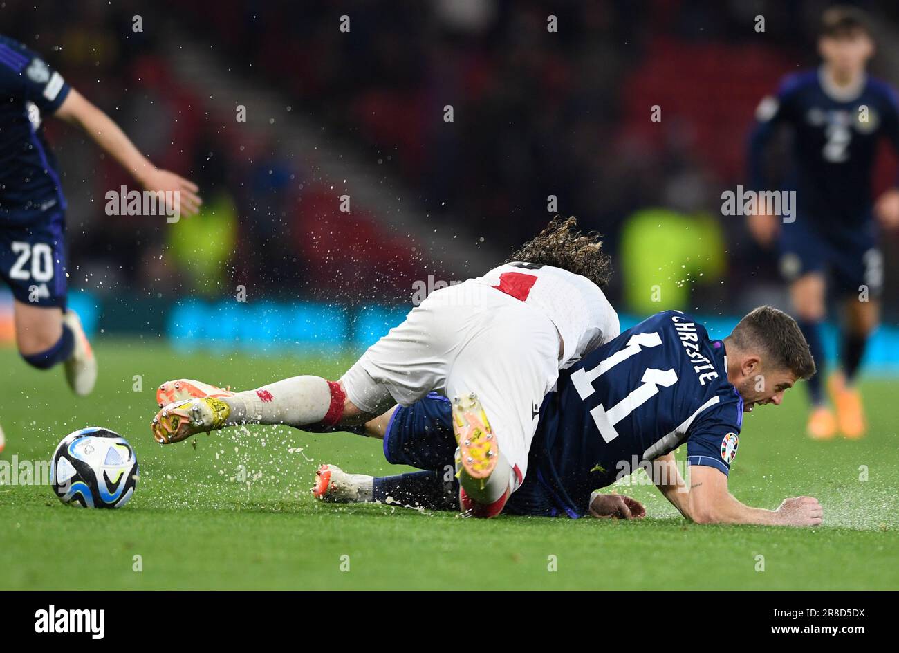 Glasgow, UK. 20th June, 2023. Luka Gagnidze of Georgia and Ryan Christie of Scotland during the UEFA European Championship Qualifying match at Hampden Park, Glasgow. Picture credit should read: Neil Hanna/Sportimage Credit: Sportimage Ltd/Alamy Live News Stock Photo
