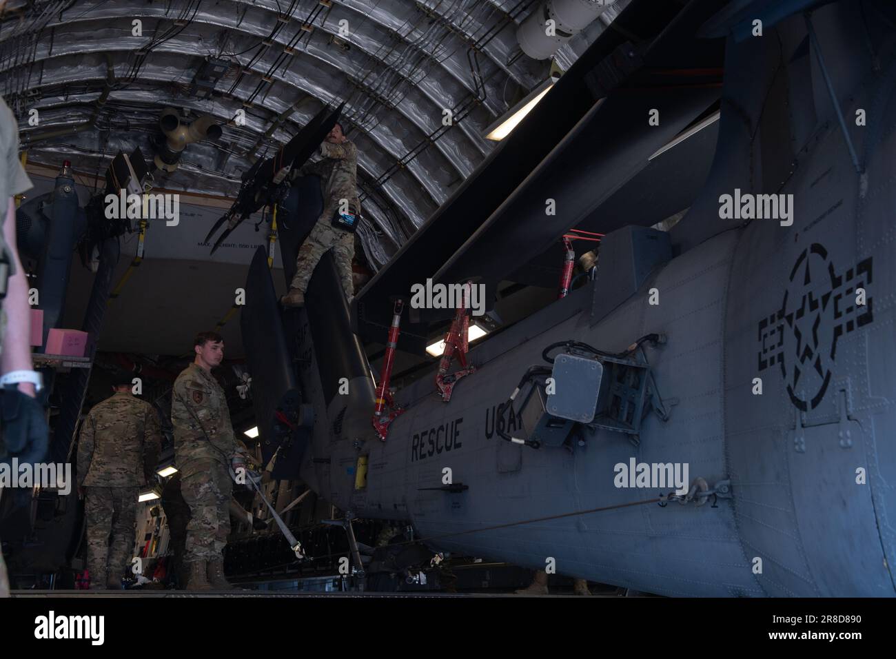 Airmen from the 33rd Rescue Squadron prepare to offload an HH-60 Pave Hawk during Red Flag-Alaska 2023 at Eielson Air Force Base, Alaska, June 15, 2023. In addition to aircrew, Red Flag-Alaska provides training for deployed maintenance and support personnel in sustainment of large-force deployed air operations. (U.S Air Force photo by Senior Airman Cedrique Oldaker) Stock Photo