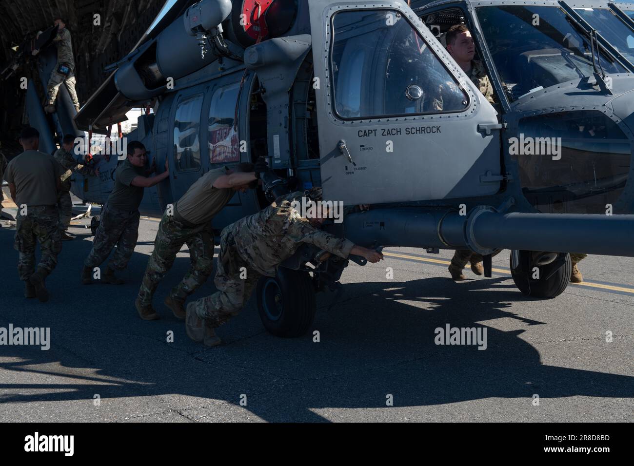 Airmen from the 33rd Rescue Squadron offload an HH-60 Pave Hawk during Red Flag-Alaska 2023 at Eielson Air Force Base, Alaska, June 15, 2023. The Joint Pacific Alaska Range Complex airspace covers more than 77,000 square miles and provides a realistic training environment, allowing Airmen to train for full spectrum engagements, ranging from individual skills to complex, large-scale joint engagements. (U.S Air Force photo by Senior Airman Cedrique Oldaker) Stock Photo