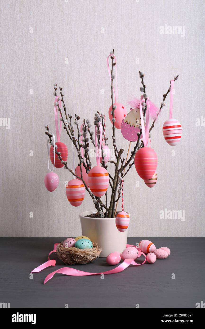 Beautiful willow branches with painted eggs and Easter decor on light ...
