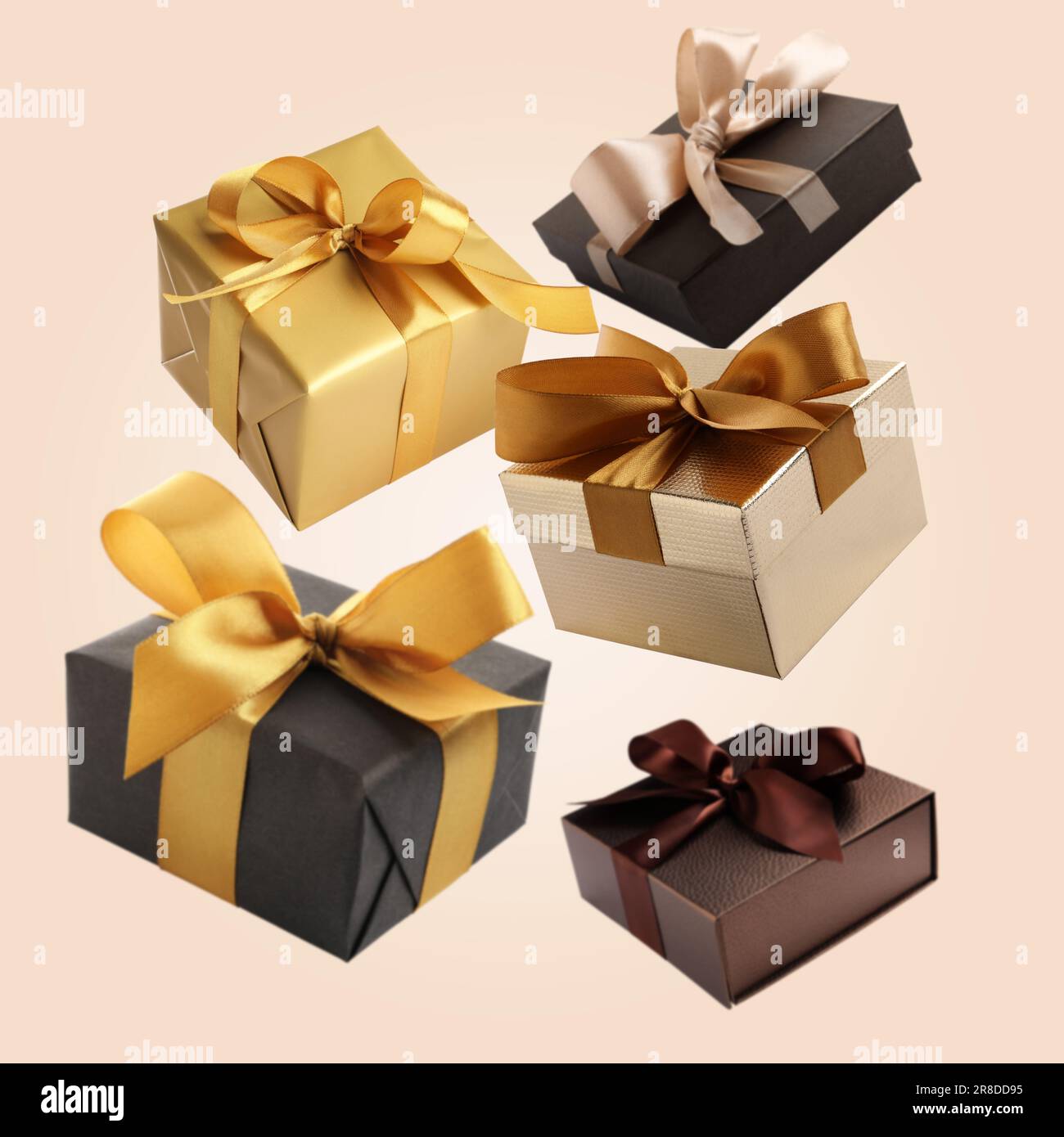 Many beautiful gift boxes falling on beige background Stock Photo - Alamy
