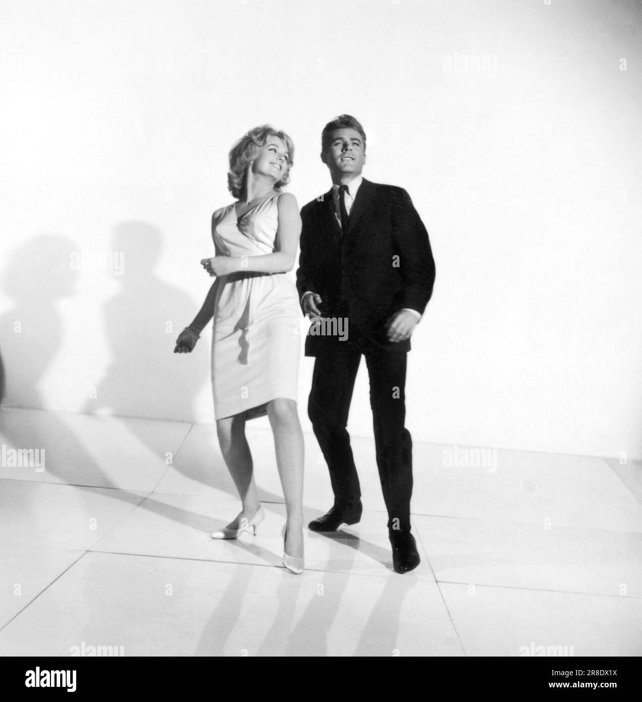 United States:  c. 1961 A photograph of a couple demonstrating how to dance the twist. Stock Photo