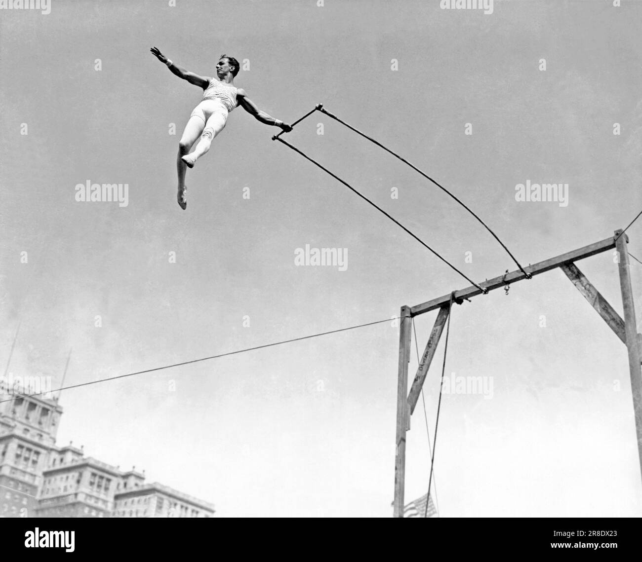 United States c. 1933. Alfredo Codona, trapeze artist, at the apex of