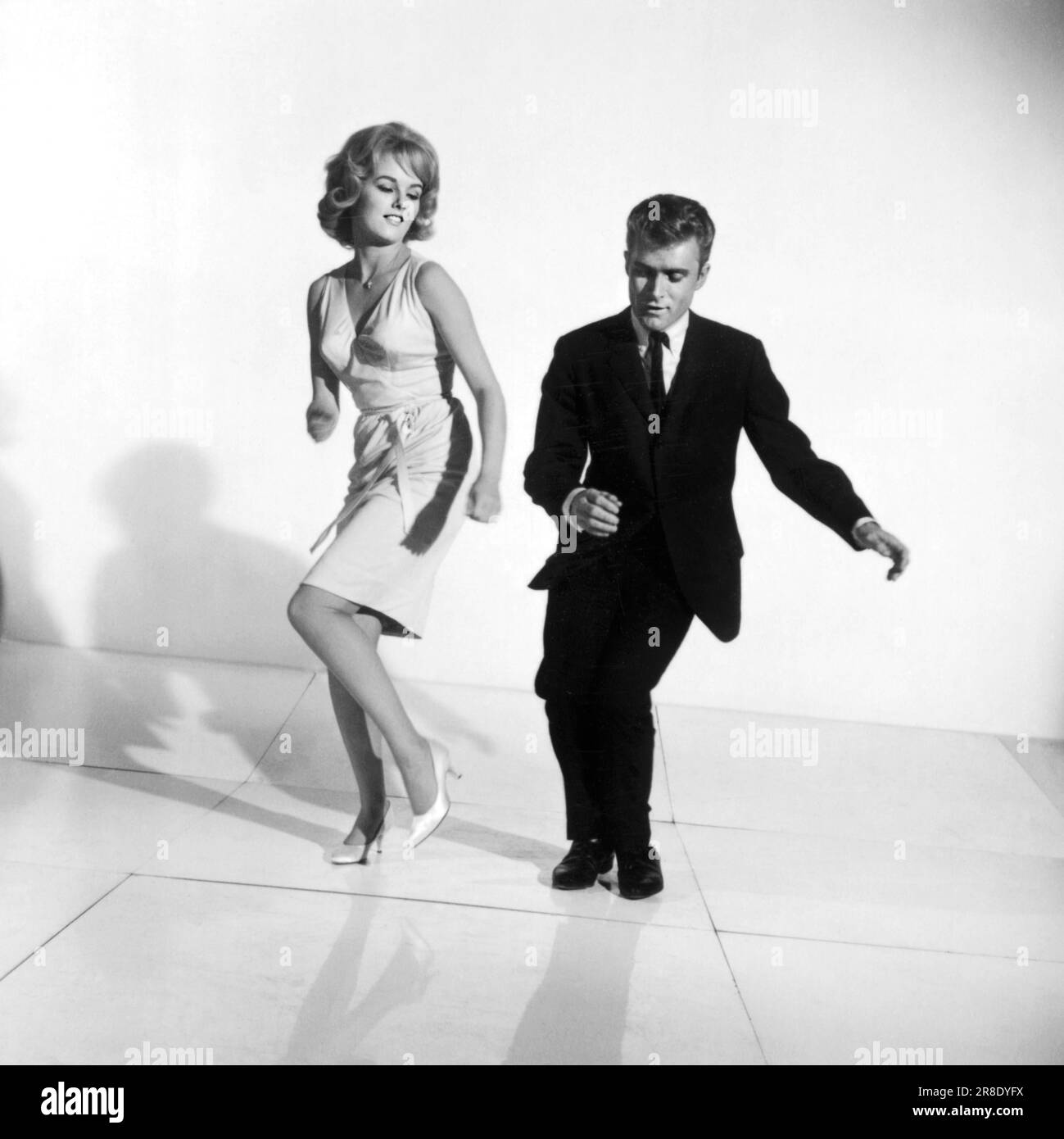 United States:  c. 1961 A photograph of a couple demonstrating how to dance the twist. Stock Photo