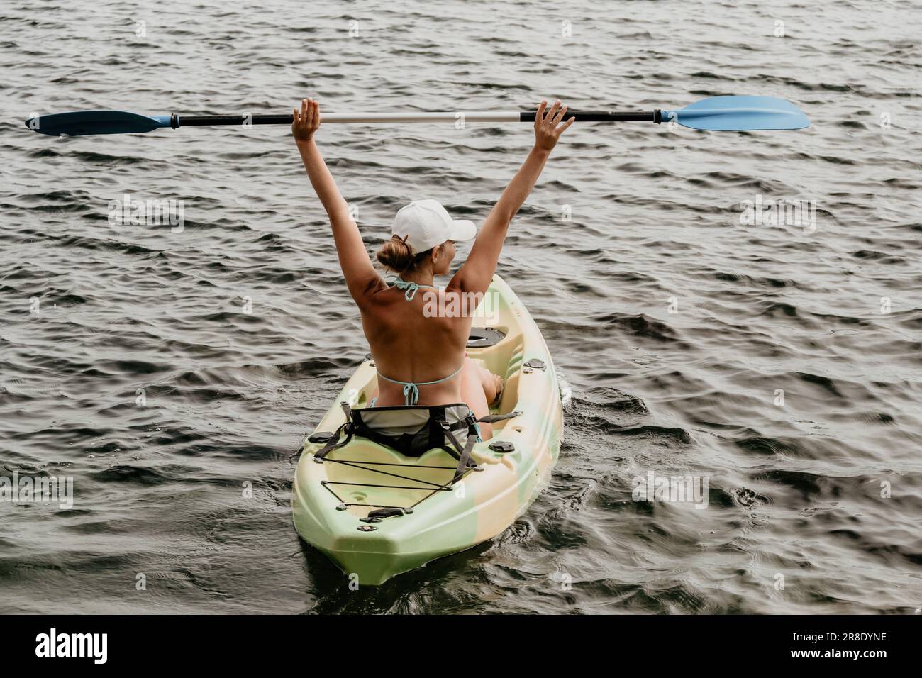 Woman kayak sea. Happy woman kayaks in sea, capturing outdoor memory