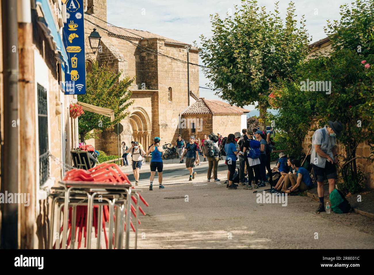 xterior of store selling religious items with motion blurred tourists and pilgrims in foreground. spain - may 2023. High quality photo Stock Photo