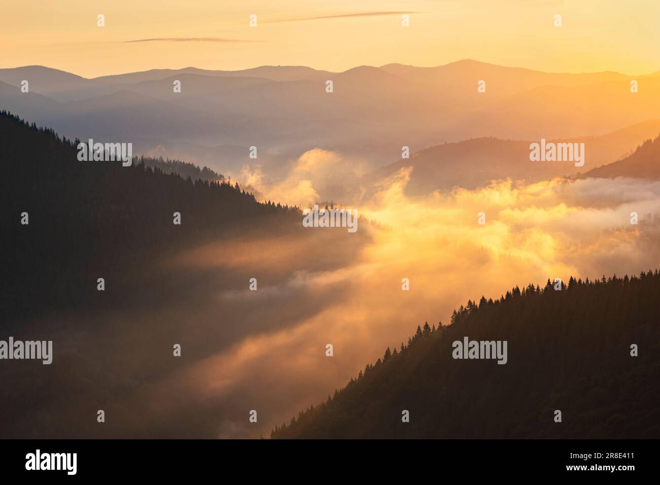 Ukraine, Ivano Frankivsk region, Verkhovyna district, Dzembronya village, Foggy Carpathian Mountains landscape at sunset Stock Photo