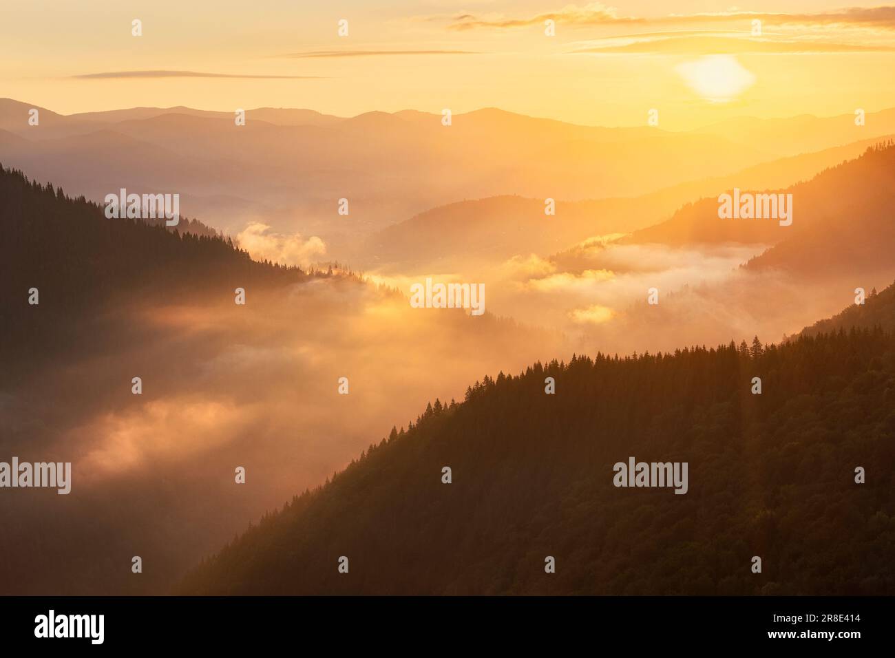 Ukraine, Ivano Frankivsk region, Verkhovyna district, Dzembronya village, Foggy Carpathian Mountains landscape at sunset Stock Photo