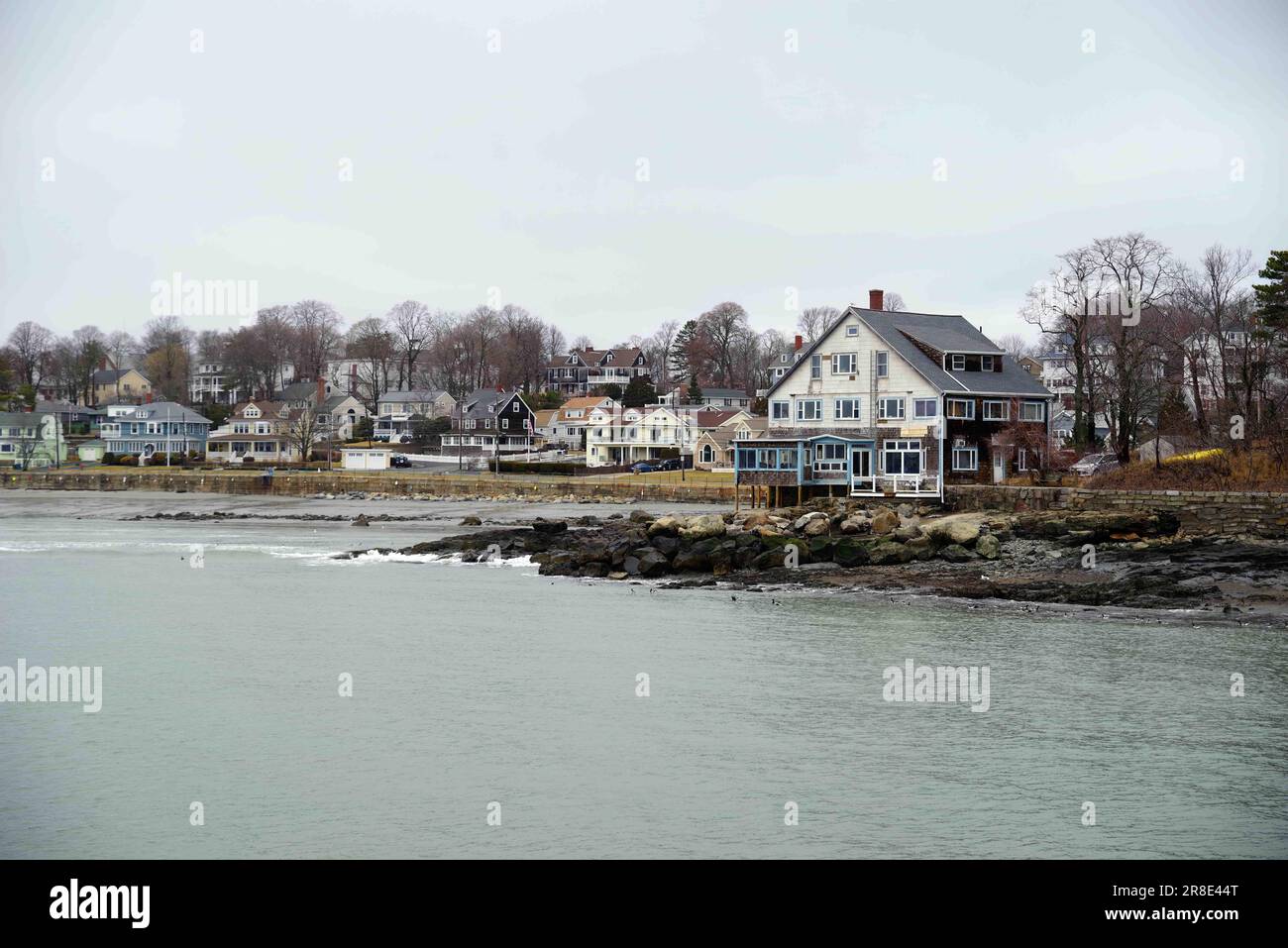 Row of houses on a quaint moody New England seascape coastline Stock
