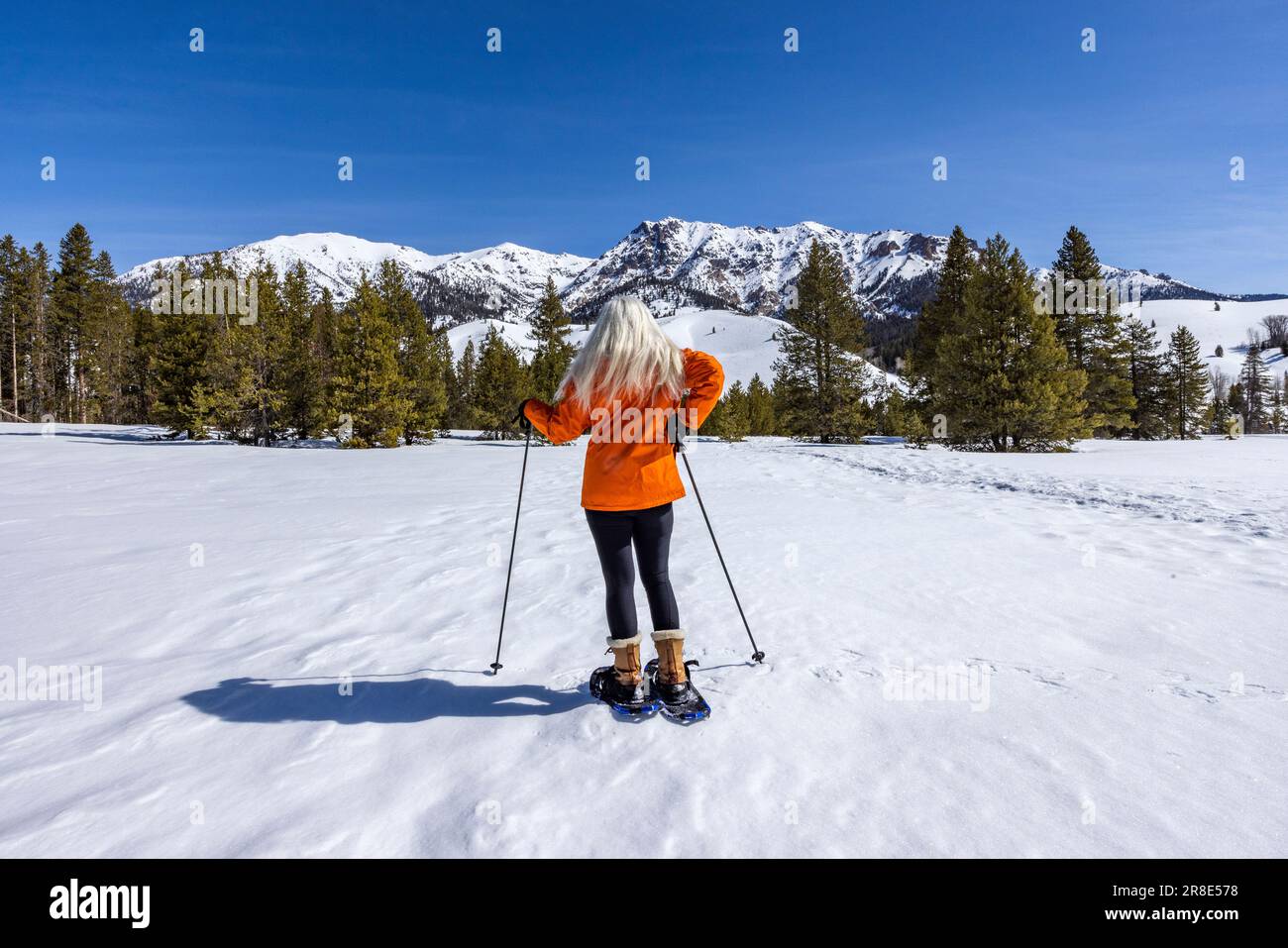 USA, Idaho, Ketchum, Back view of woman snowshoeing in mountains Stock