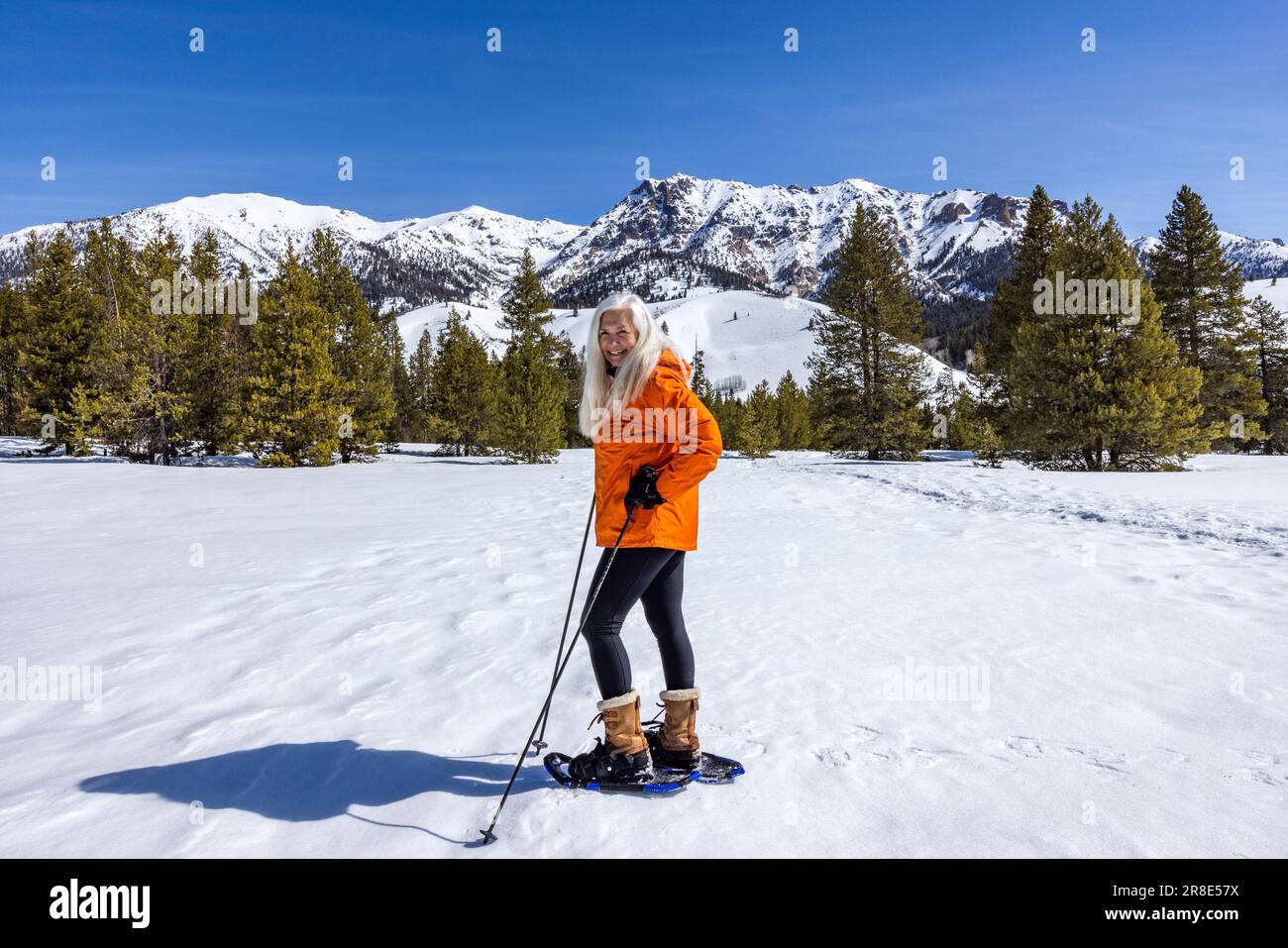 USA, Idaho, Ketchum, Smiling woman snowshoeing in mountains Stock Photo