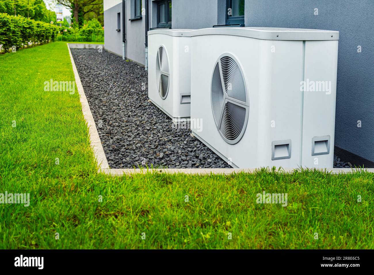 Two air source heat pumps installed outside of new and modern city