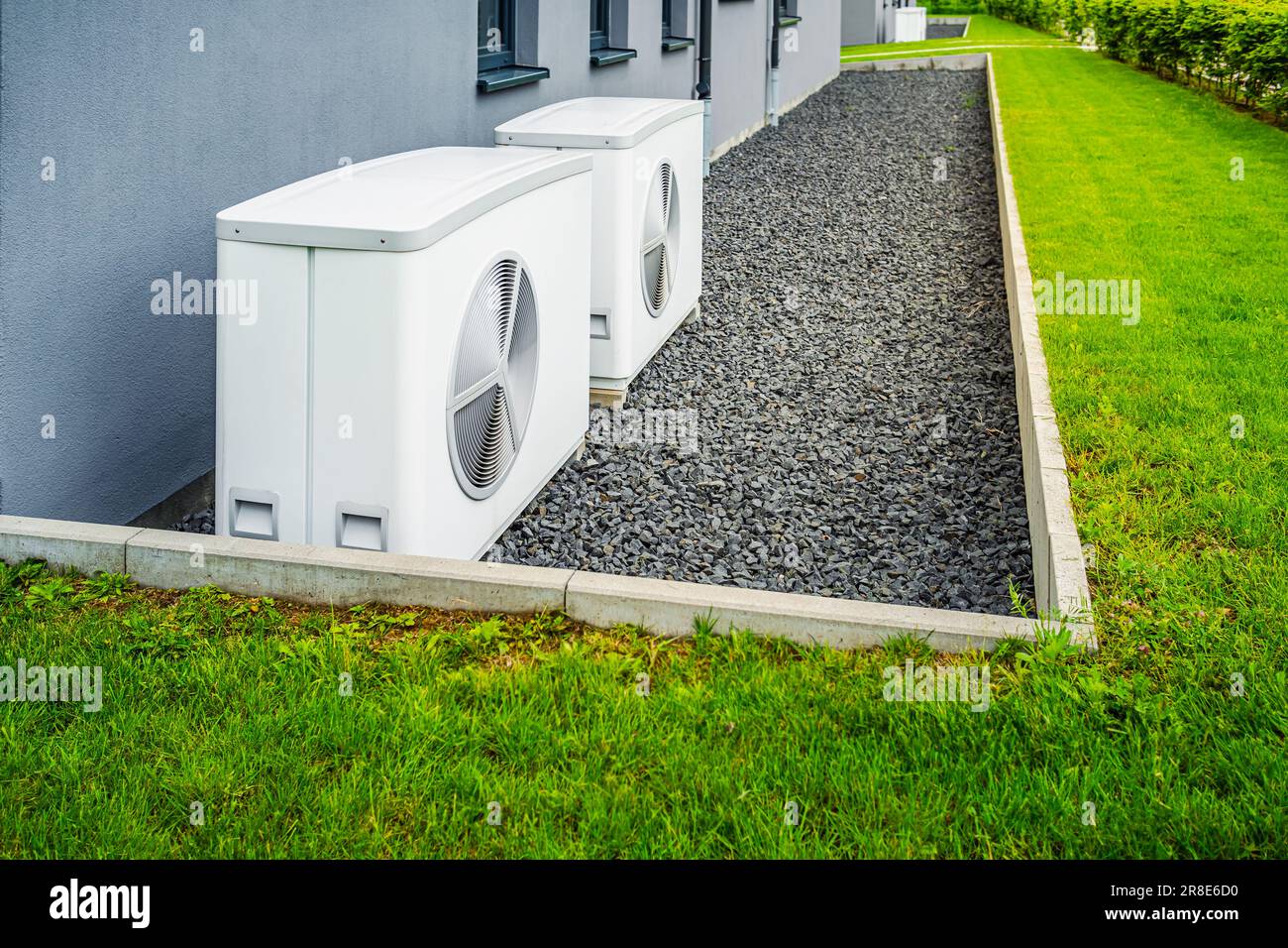 Two air source heat pumps installed outside of new and modern city