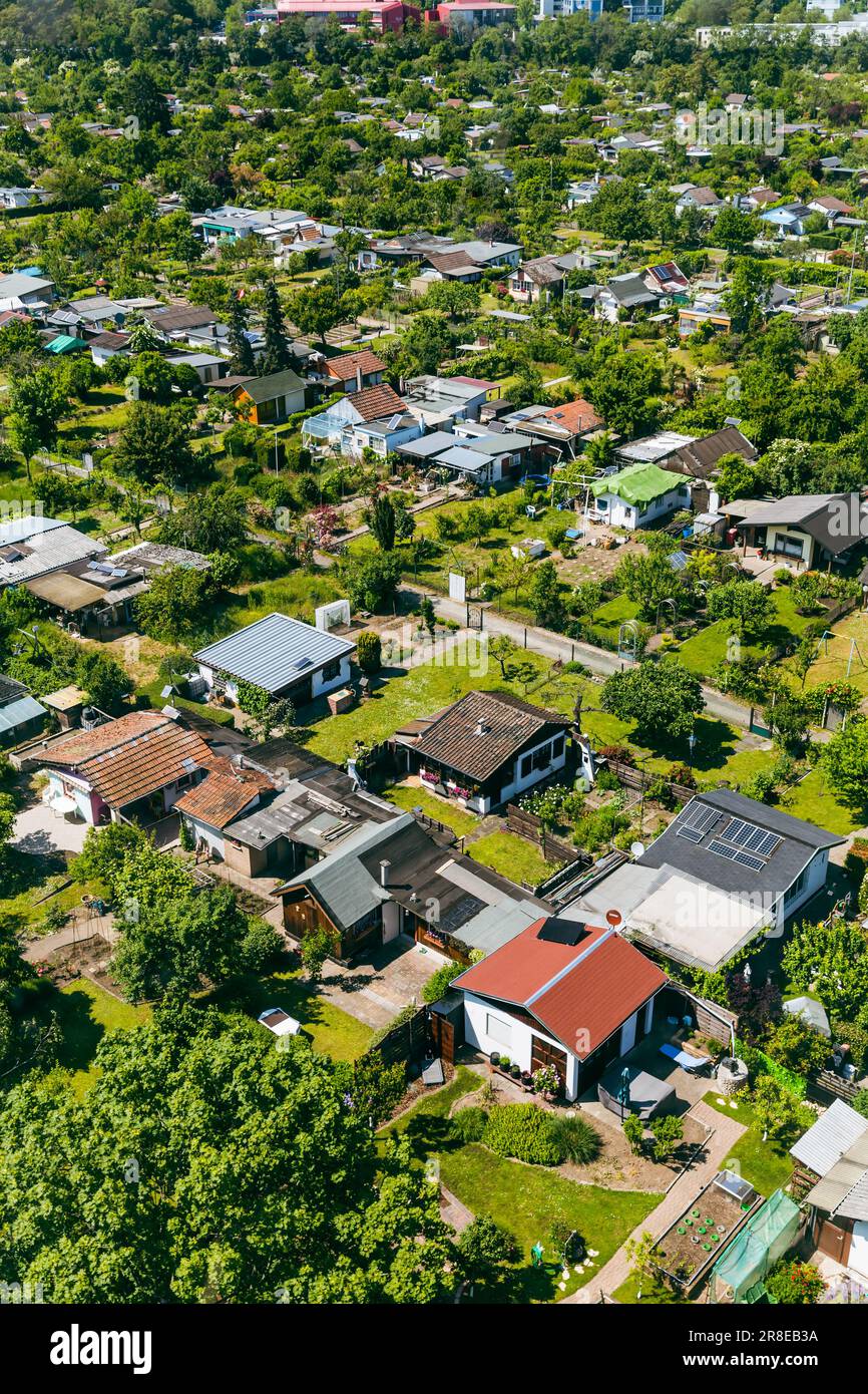 Aerial view of a cluster of houses and gardens in Mannheim, Germany. Suburb and urbanization concept, tightly packed homes. Stock Photo