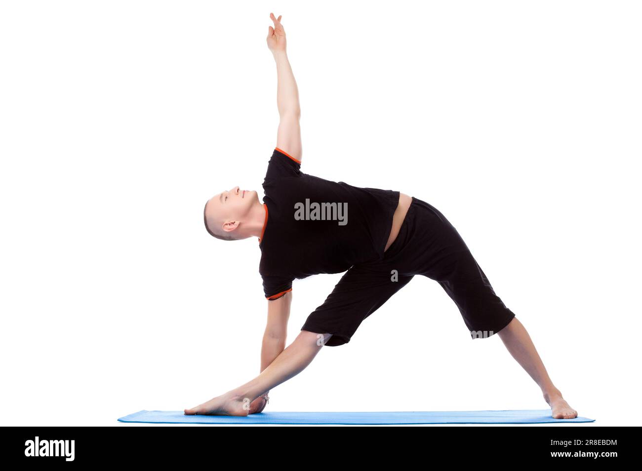 Energetic middle-aged man doing yoga poses Stock Photo - Alamy