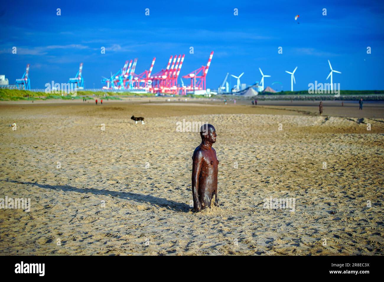 People enjoying the warm weather at Another Place, Anthony Gormley's Ironmen statues on Crosby Beach, Merseyside, on the eve of the Summer Solstice. Picture date: Tuesday June 20, 2023. Stock Photo