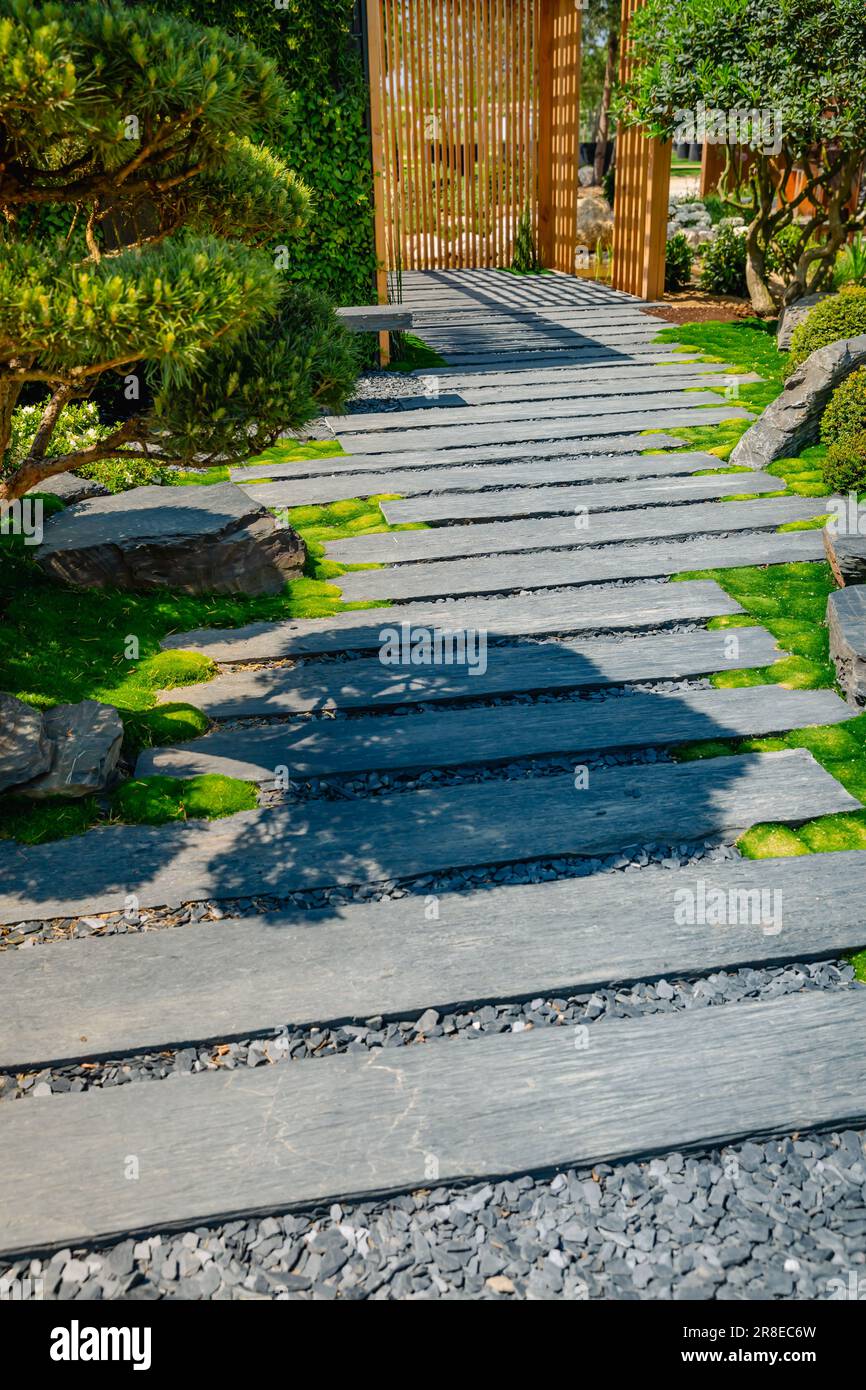 Detail of slate path with bark mulch and native plants in Japanese