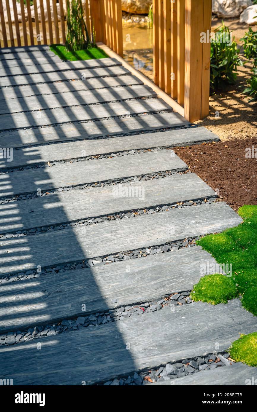 Detail of slate path with bark mulch and native plants in Japanese