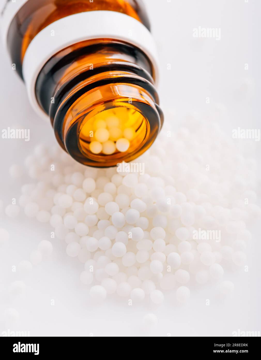 Homeopathic globules and glass bottle. Homeopathy, alternative medicine. Stock Photo