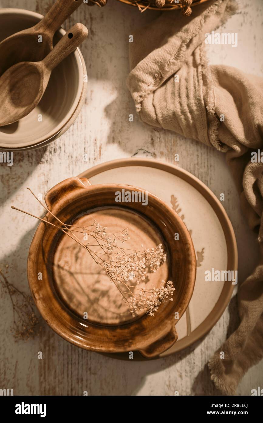 Set of ceramic tableware. Empty craft ceramic plates, bowls and cups kitchen table Stock Photo