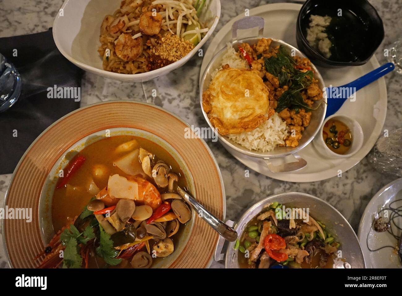 Close up Pad Thai, Stir fry noodles with shrimp and tamarind sauce served with pork soup and spicy salad Stock Photo