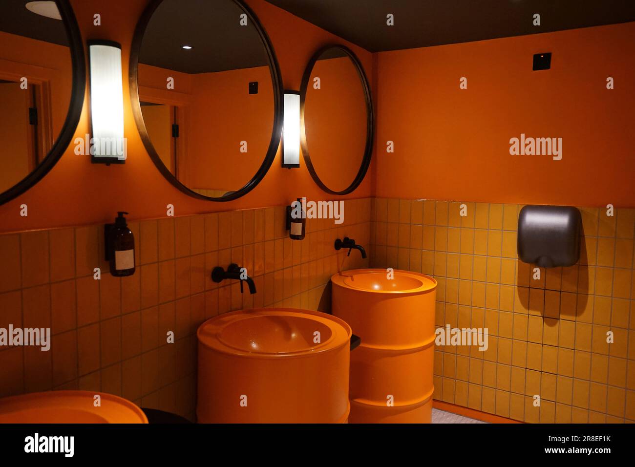 Interior design and decoration of public restroom in orange colored