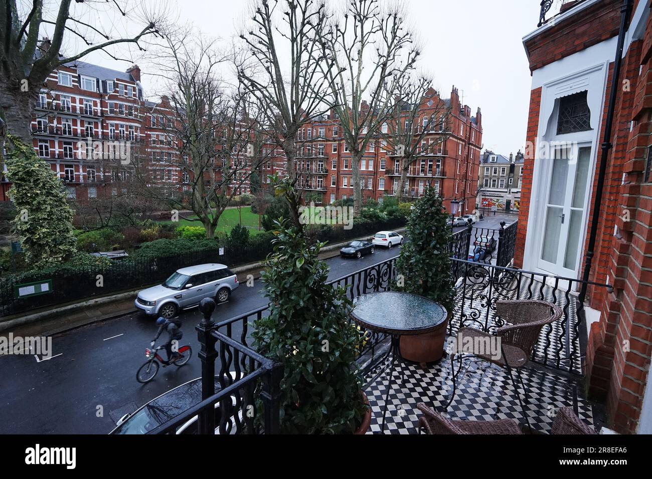 Exterior European design and architecture decoration of British hotel, balcony and terrace facing natural green public park- London, UK Stock Photo