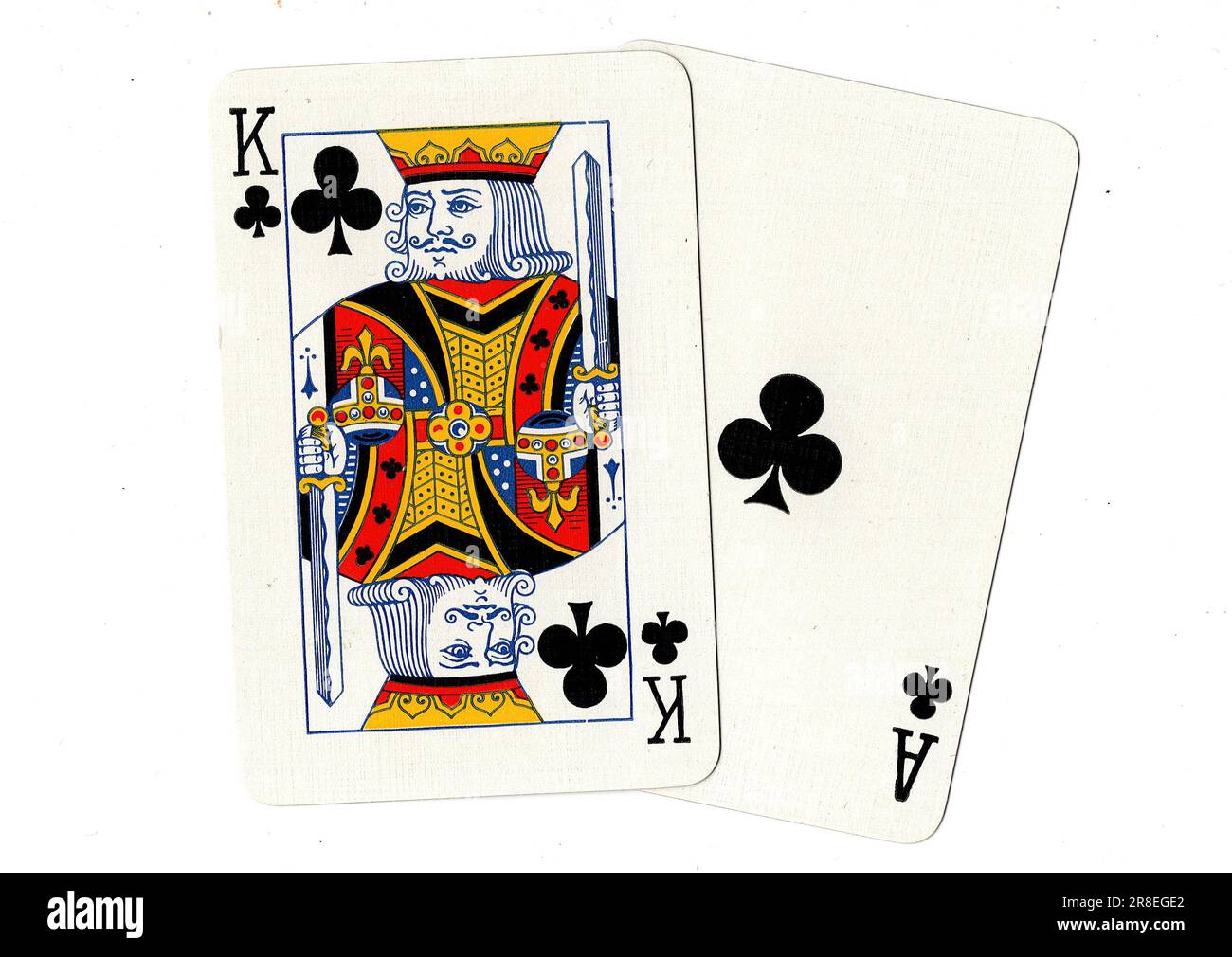 A pair of vintage playing cards featuring a king and ace of clubs on a