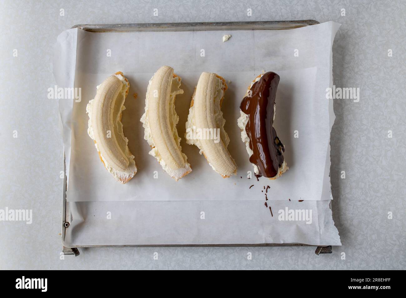 Making chocolate bananas with sponge cake and whipped cream. Part of a